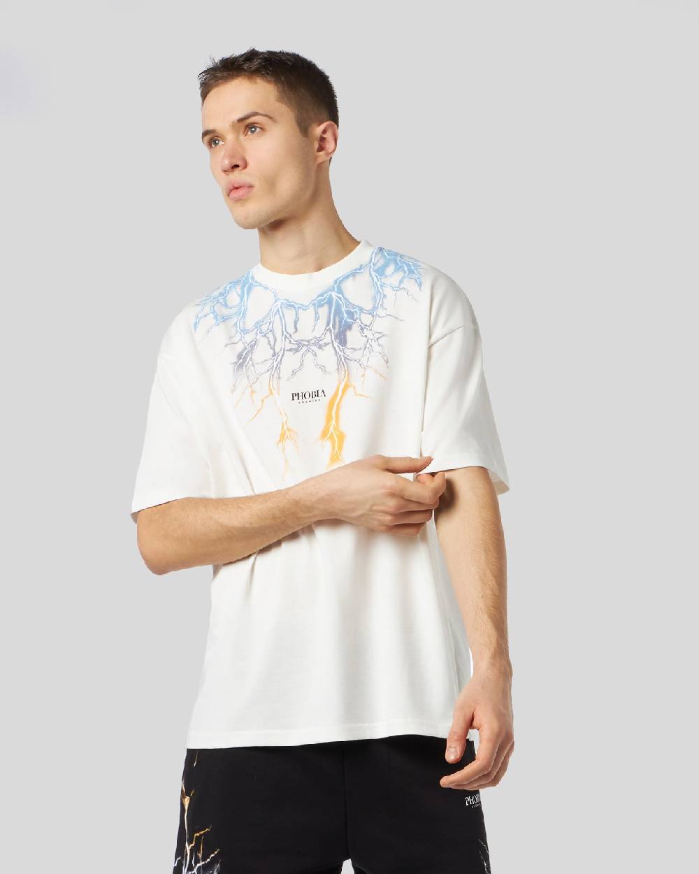 Phobia Archive T-SHIRT BIANCA CON FULMINI BICOLORE GIALLO E BLU Pezzi Unici